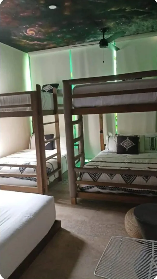 Habitación con literas y techo pintado como galaxia en el penthouse Tuluna